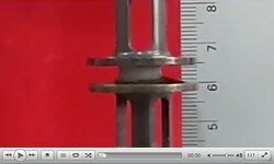 Video of a porous composite being compressed between two metal plates.